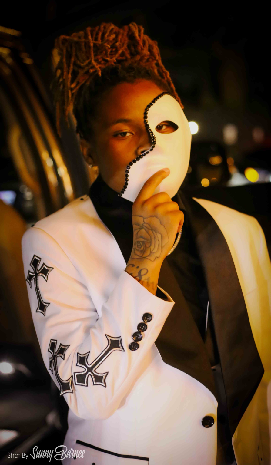 Jayluvv holding a white half-face mask