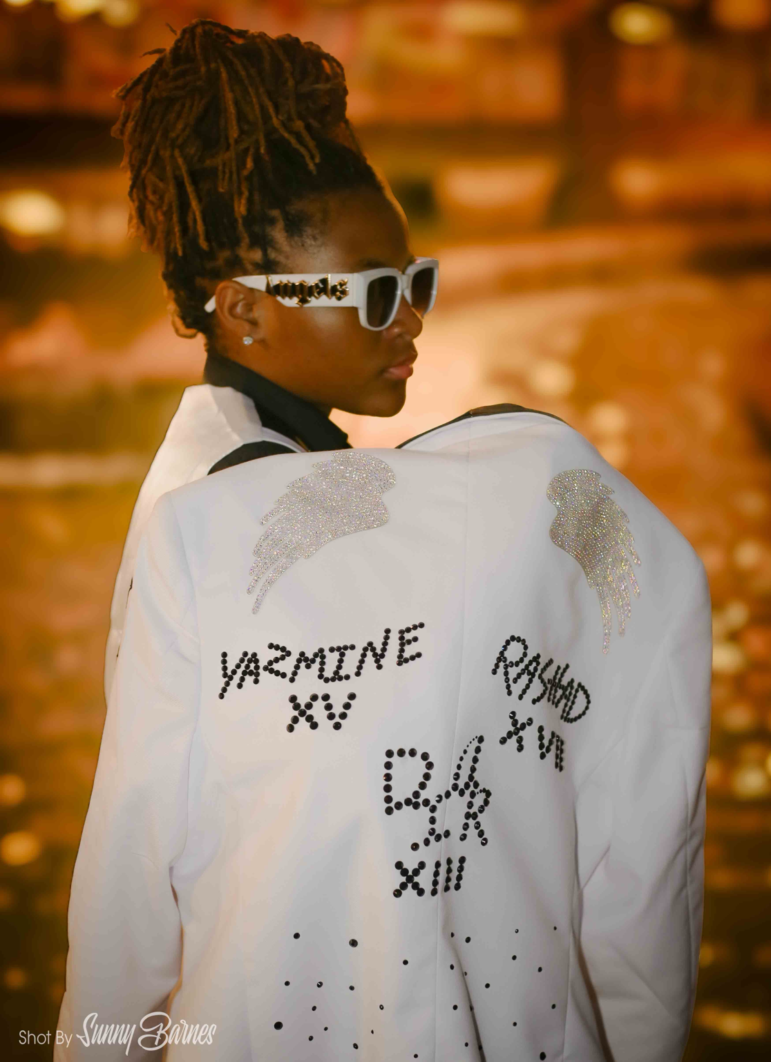 Jayluvv in a rear-facing white jacket portrait
